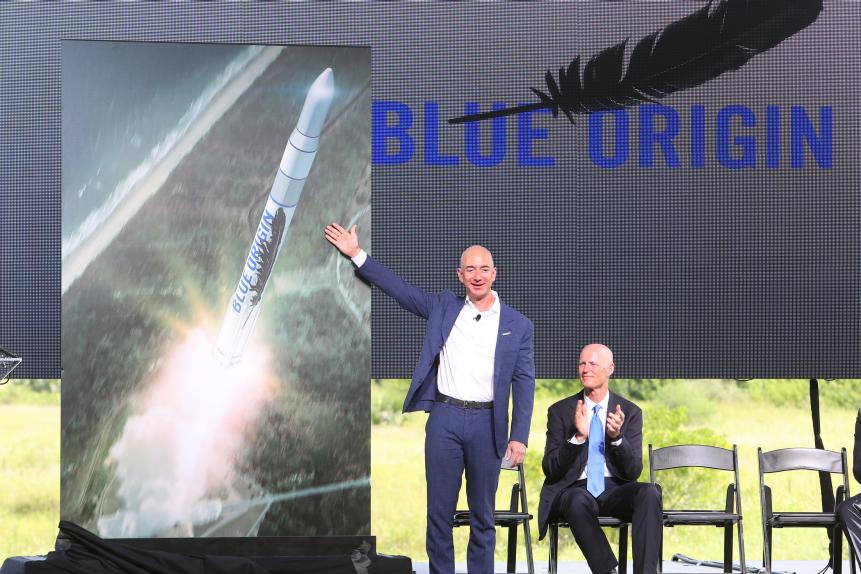 Amazon.com CEO and Blue Origin founder Jeff Bezos, left, debuts a launch vehicle on Tuesday, Sept. 15, 2015, as Florida Gov. Rick Scott applauds during a press conference at launch complex 36 at Cape Canaveral Air Force Station. Bezos said his company would bring over 300 new jobs to Florida's space coast. (Red Huber/Orlando Sentinel/Tribune News Service via Getty Images)