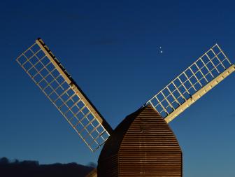 BRILL, ENGLAND - DECEMBER 20:  Jupiter and Saturn are seen coming together in the night sky, over the sails of Brill windmill, for what is known as the Great Conjunction, on December 20, 2020 in Brill, England. The planetary conjunction is easily visible in the evening sky and will culminate on the night of December 21. This is the closest the planets have appeared for nearly 800 years. (Photo by Jim Dyson/Getty Images)