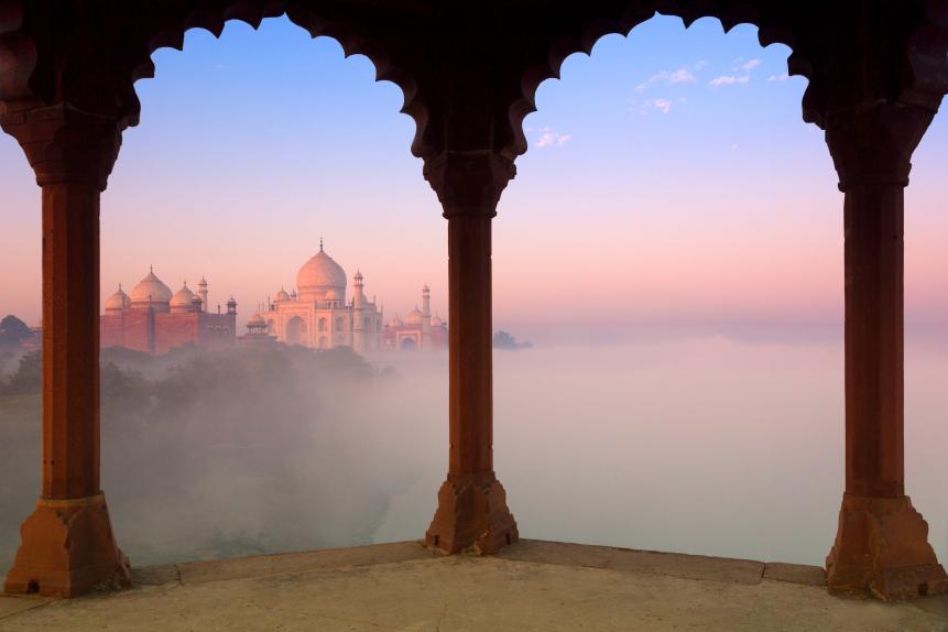 India, Uttar Pradesh, Agra, Taj Mahal and early morning fog framed by arches