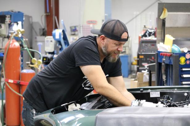 Brian Bass works on the engine of the ’68 Mustang