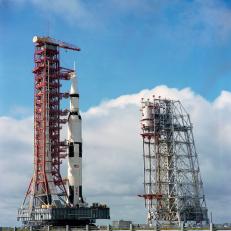 Cape Canaveral, Florida, September 8, 1969 - Ground-level view at Launch Complex 39, Kennedy Space Center, showing the Apollo 12 (Spacecraft 108/ Lunar Module 6/ Saturn 507) space vehicle on the way from the Vehicle Assembly Building to the launch pad. The Saturn V stack and its mobile launch tower are atop a huge crawler-transporter. The Launch Complex 39 service structure is on the right. Apollo 12 is scheduled as the second lunar landing mission.