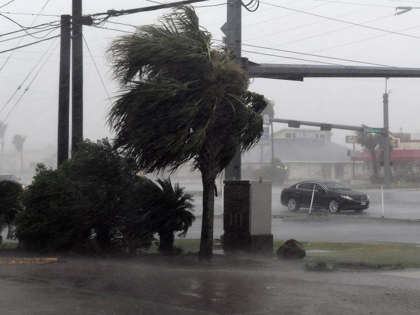 TOPSHOT - A motorist drives through heavy rain before the approaching Hurricane Harvey hits Corpus Christi, Texas on August 25, 2017. 
 Hurricane Harvey will soon hit the Texas coast with forecasters saying its possible for up to 3 feet of rain and 125 mph winds. / AFP PHOTO / MARK RALSTON        (Photo credit should read MARK RALSTON/AFP/Getty Images)