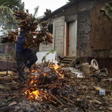 SAN ISIDRO, PUERTO RICO - OCTOBER 05:  Resident Francisco Duran burns downed tree limbs on his property about two weeks after Hurricane Maria swept through the island on October 5, 2017 in San Isidro, Puerto Rico. Residents in his section of the town remain without grid power or running water. Puerto Rico experienced widespread damage including most of the electrical, gas and water grid as well as agriculture after Hurricane Maria, a category 4 hurricane, swept through.  (Photo by Mario Tama/Getty Images)