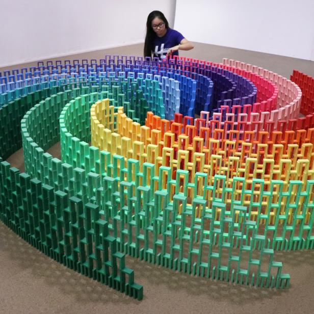 Domino artist Lily Hevesh builds a rainbow spiral