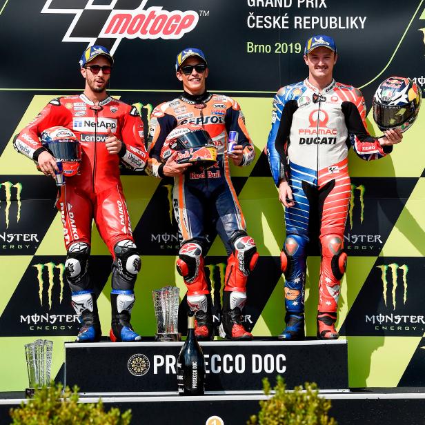 (L to R) Second placed Mission Winnow Ducati's Italian rider Andrea Dovizioso, winner Repsol Honda Team's Spanish rider Marc Marquez and third placed Pramac Racing's Australian rider Jack Miller pose on the podium of the Moto GP Czech Grand Prix in Brno on August 4, 2019. (Photo by Michal CIZEK / AFP)        (Photo credit should read MICHAL CIZEK/AFP/Getty Images)