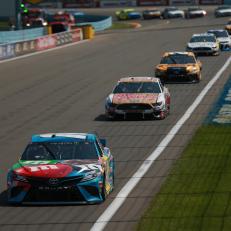 WATKINS GLEN, NEW YORK - AUGUST 04: Kyle Busch, driver of the #18 M&M's Hazelnut Toyota, leads a pack of cars during the Monster Energy NASCAR Cup Series Go Bowling at The Glen at Watkins Glen International on August 04, 2019 in Watkins Glen, New York. (Photo by Sean Gardner/Getty Images)