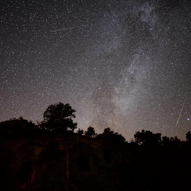 USAK, TURKEY - AUGUST 13: Perseid meteors streak across the night sky over the ancient city of Mesotimolos in Esme district of Turkey's western Usak province on August 13, 2019. Visitors observed 60 to 80 meteors that were visible with the naked eye.  (Photo by Soner Kilinc/Anadolu Agency via Getty Images)