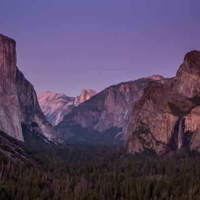 YOSEMITE VALLEY, CA - AUGUST 13:  Yosemite Valley is bathed in pink light following sunset as viewed from Tunnel View on August 13, 2019, in Yosemite Valley, California. With the arrival of summer, the estimated 600,000 monthly visitors endure traffic congestion, road construction projects, and hot weather, in addition to the scenic beauty. (Photo by George Rose/Getty Images)