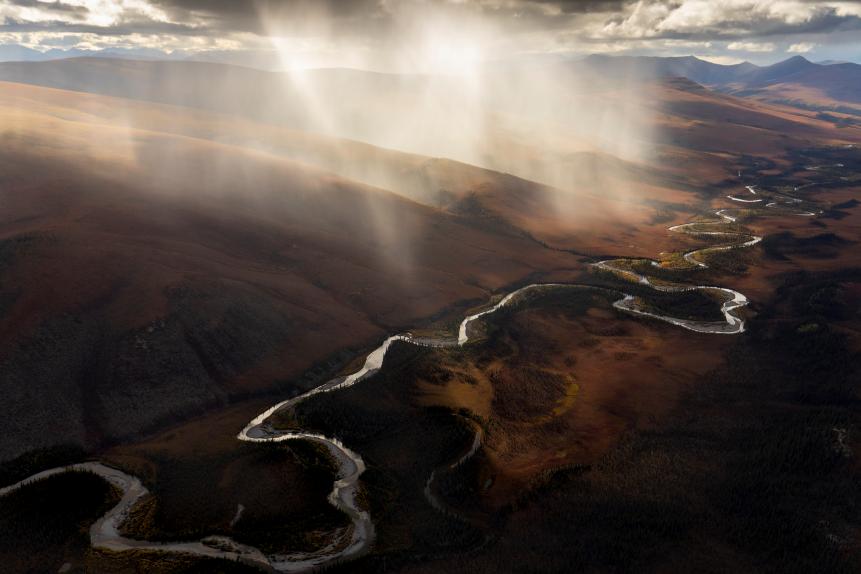 I asked the pilot to circle around again, attempting to get closer and closer to the small rain squall that had formed over the river. The fall colors and dramatic light created the best composition I've ever made deep in the interior of Arctic National Wildlife Refuge, Alaska.