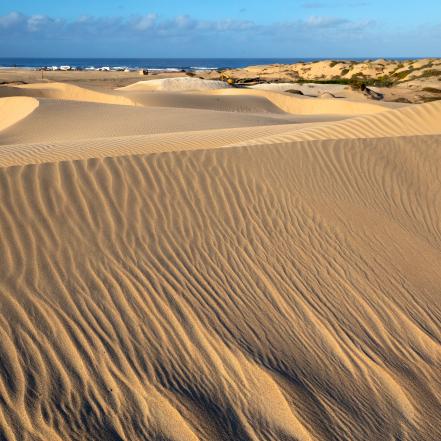 Storytelling is about layers. This image works for me, because it has a conservation foreground, with pristine, footprint-free dunes, and a beach with visible recreation on it, helping illustrate the story.