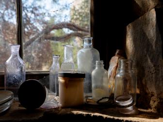 Detail of historic replica bottles that once lined the window of the Eagle Cliff Mine in Joshua Tree National Park, California