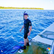 Robert Irwin smiling in snorkel gear, standing at the stern of Croc One before snorkeling at Lady Elliot Island, Australia