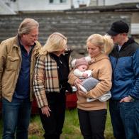 Sig Hansen, June Hansen, Mandy Hansen holding baby, and Clark Pederson standing together.