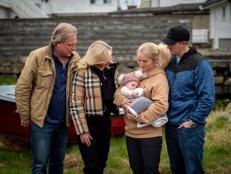Sig Hansen, June Hansen, Mandy Hansen holding baby, and Clark Pederson standing together.