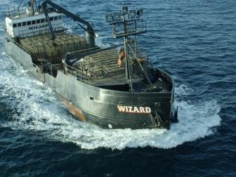 The Wizard steams through the Bering Sea while the crew stacks crab pots.