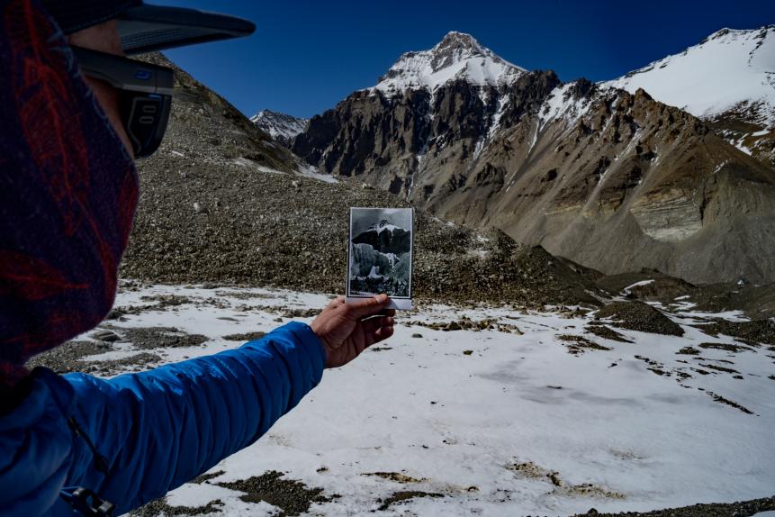 Sid Pattison holding up and photo Jake Norton brought of the 1924 Camp 2, matching it to the skyline, allowing he and Jake to be sure they were in the right spot.