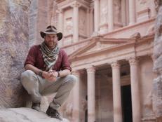 Josh Gates amidst ruins in Petra, Jordan.