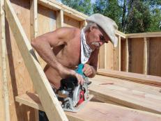 Marty Raney sanding wood beams