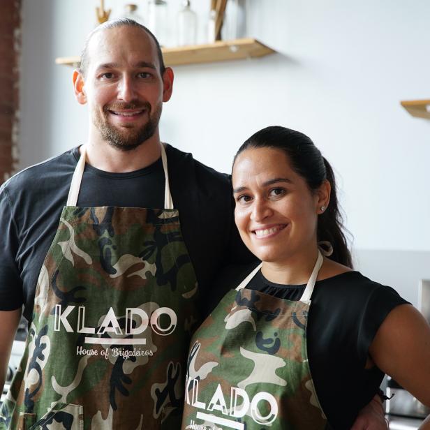 Jesse Klee and Jen Prado pose for a photo in their Klado aprons