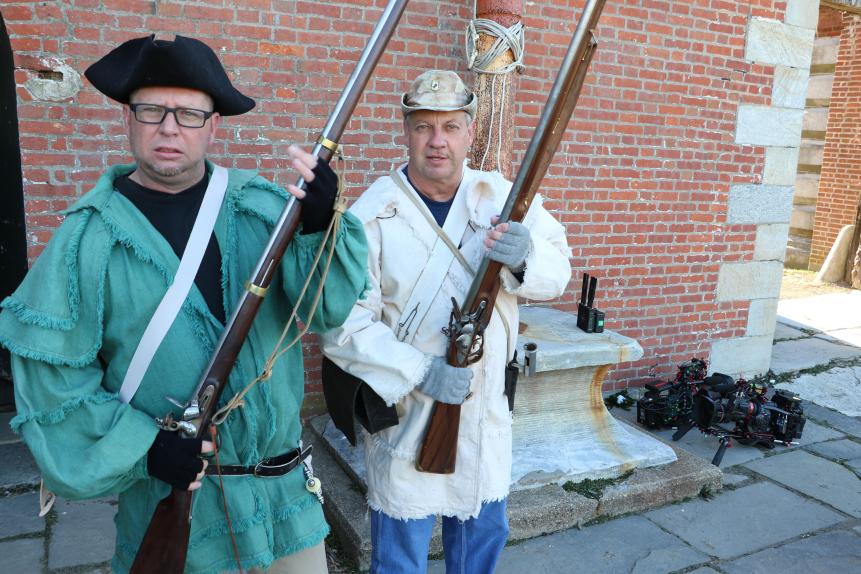 Behind the scenes: Howard and Tim pose with their muskets as they learn about Benjamin Franklin and spruce beer.