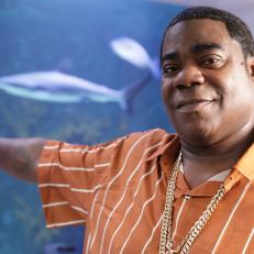 Tracy Morgan poses in front of his fish tank on Sharks of the West Coast (Sharkadelic 3).
