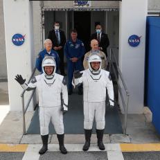 CAPE CANAVERAL, FLORIDA - MAY 27: NASA astronauts Bob Behnken (R) and Doug Hurley (L) walk out of the Operations and Checkout Building on their way to the SpaceX Falcon 9 rocket with the Crew Dragon spacecraft on launch pad 39A at the Kennedy Space Center on May 27, 2020 in Cape Canaveral, Florida. NASA will try again on Saturday for the inaugural flight that will be the first manned mission since the end of the Space Shuttle program in 2011 to be launched into space from the United States.  (Photo by Joe Raedle/Getty Images)