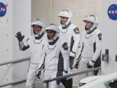 CAPE CANAVERAL, FLORIDA - NOVEMBER 10: (L-R front) NASA astronauts Tom Marshburn and Raja Chari and (L-R back) European Space Agency astronaut Matthias Maurer of Germany and NASA astronaut Kayla Barron walk out of the Operations and Checkout Building on their way to the SpaceX Falcon 9 rocket with the Crew Dragon spacecraft on launch pad 39A at the Kennedy Space Center on November 10, 2021 in Cape Canaveral, Florida. The astronauts are scheduled to lift off at 9:03pm to the International Space Station. (Photo by Joe Raedle/Getty Images)