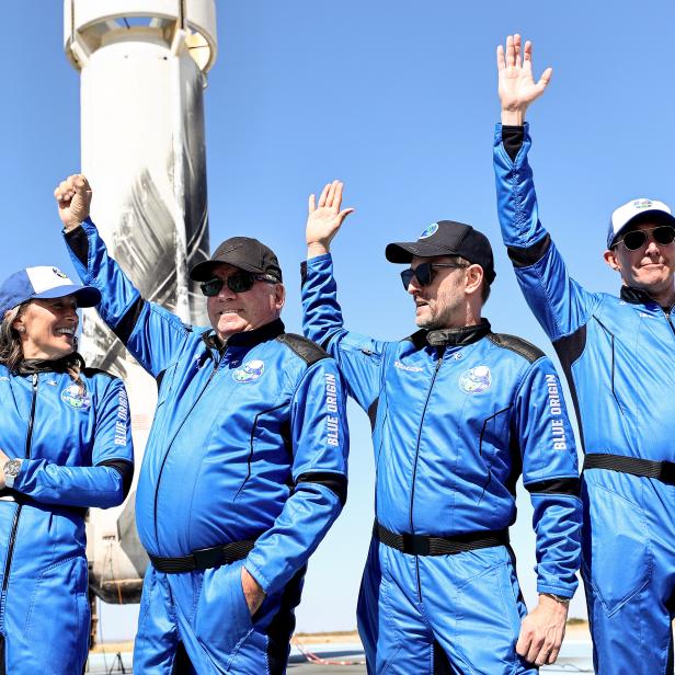 VAN HORN, TEXAS - OCTOBER 13: (L-R) Blue Origins vice president of mission and flight operations Audrey Powers, Star Trek actor William Shatner, Planet Labs co-founder Chris Boshuizen and Medidata Solutions co-founder Glen de Vries wave during a media availability on the landing pad of Blue Originâ  s New Shepard after they flew into space on October 13, 2021 near Van Horn, Texas. Shatner became the oldest person to fly into space on the ten minute flight. They flew aboard mission NS-18, the second human spaceflight for the company which is owned by Amazon founder Jeff Bezos. (Photo by Mario Tama/Getty Images)