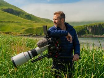 Alaska Maritime National Wildlife Refuge, Aleutian Islands, Alaska: Host of The Last Unknown, Ian Shive, with his cinematography camera.