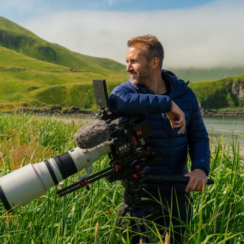 Alaska Maritime National Wildlife Refuge, Aleutian Islands, Alaska: Host of The Last Unknown, Ian Shive, with his cinematography camera.