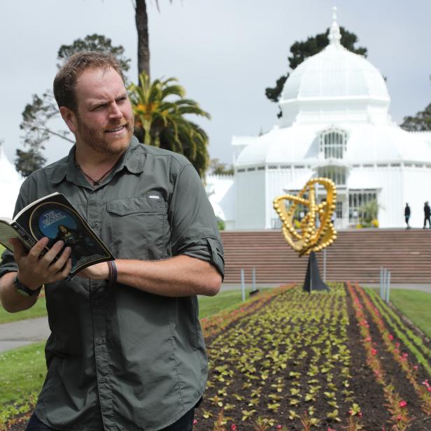 Josh Gates searches for a treasure from the book The Secret in Golden Gate Park of San Francisco, California.