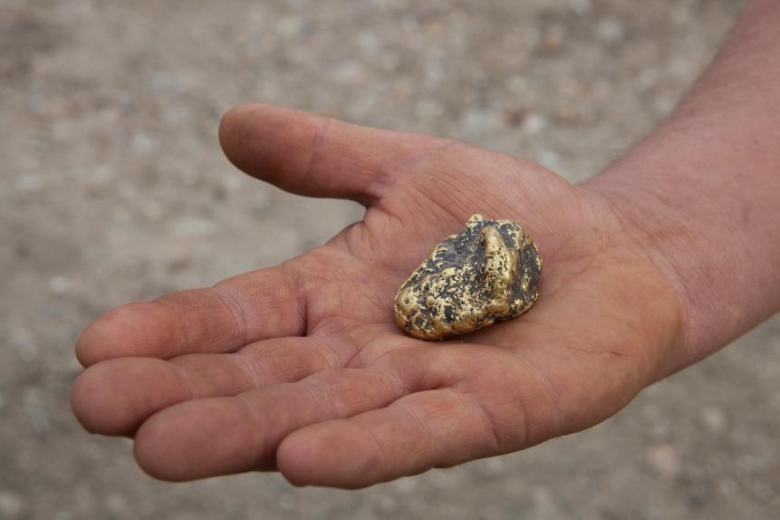 Gold nugget in hands.