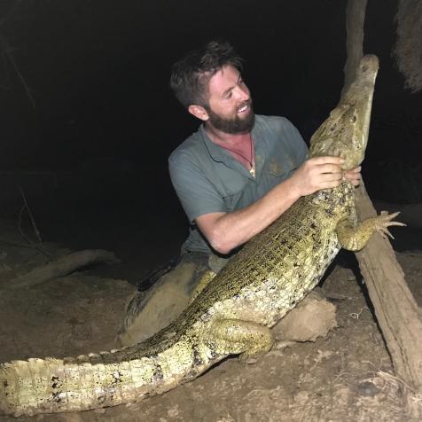 Forrest Galante With The Caiman He Caught Wide Shot