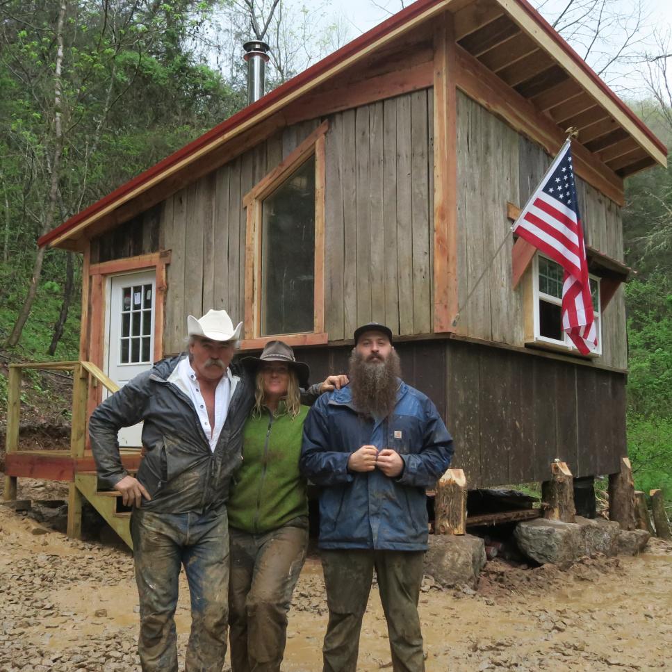 Marty, Misty and Matt (left to right) stand in front of the newly built cabin.