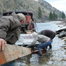 Buck Dewey, Joni Dewey, and Heinz Sippel work to remove the duck boat ramp.