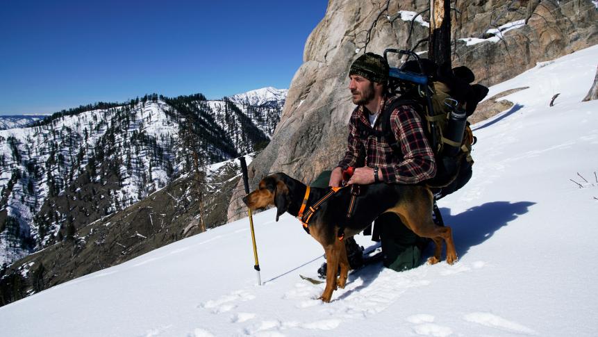Pete Metz with his dog, Hildie on a mountain.