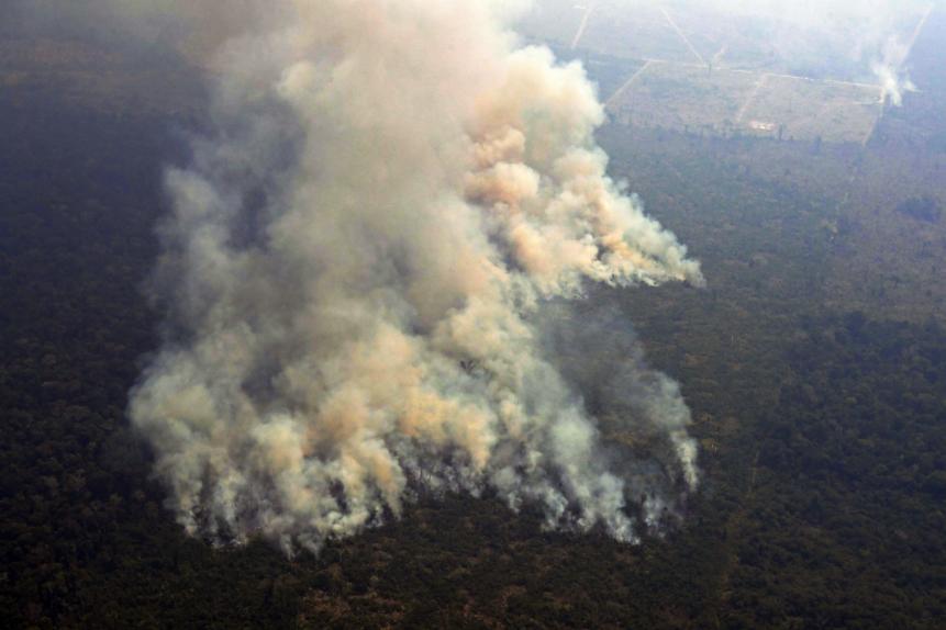Aerial picture showing smoke from a two-kilometre-long stretch of fire billowing from the Amazon rainforest about 65 km from Porto Velho, in the state of Rondonia, in northern Brazil, on August 23, 2019. - Bolsonaro said Friday he is considering deploying the army to help combat fires raging in the Amazon rainforest, after news about the fires have sparked protests around the world. The latest official figures show 76,720 forest fires were recorded in Brazil so far this year -- the highest number for any year since 2013. More than half are in the Amazon. (Photo by Carl DE SOUZA / AFP)        (Photo credit should read CARL DE SOUZA/AFP/Getty Images)