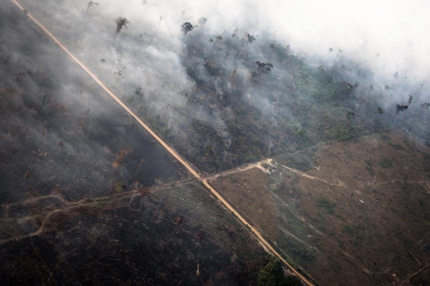 Smoke rises as a fire burns in the Amazon rainforest in this aerial photograph taken near the Candeias do Jamari region of Porto Velho, Rondonia state, Brazil, on Saturday, Aug. 24, 2019. The world's largest rainforest, Brazil's Amazon, is burning at a record rate, according to data from the National Institute of Space Research that intensified domestic and international scrutiny of President Jair Bolsonaro's environmental policies. Photographer: Leonardo Carrato/Bloomberg via Getty Images