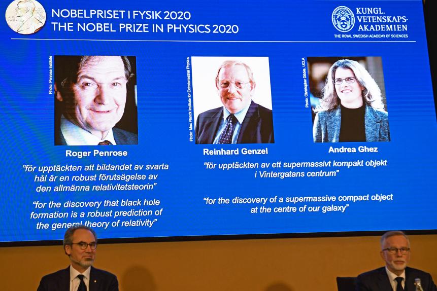 David Haviland (L), member of the Nobel Committee for Physics, and Goran K Hansson, Secretary General of the Academy of Sciences, sit in front of a screen displaying the winners of the 2020 Nobel Prize in Physics (L-R) Briton Roger Penrose, Reinhard Genzel of Germany  and Andrea Ghez of the US, during a press conference at the Royal Swedish Academy of Sciences, in Stockholm, on October 6, 2020. - Roger Penrose of Britain, Reinhard Genzel of Germany and Andrea Ghez of the US won the Nobel Physics Prize on Tuesday for their research into black holes, the Nobel jury said. (Photo by Fredrik SANDBERG / TT NEWS AGENCY / AFP) / Sweden OUT (Photo by FREDRIK SANDBERG/TT NEWS AGENCY/AFP via Getty Images)