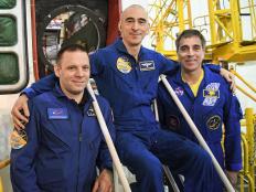 At the Baikonur Cosmodrome in Kazakhstan, Expedition 63 crewmembers Ivan Vagner (left) and Anatoly Ivanishin (center) of Roscosmos and Chris Cassidy (right) of NASA pose for pictures April 3 in front of their Soyuz spacecraft as part of their pre-launch activities. They will launch April 9 on the Soyuz MS-16 spacecraft from Baikonur on April 9 for a six-and-a-half month mission on the International Space Station.Courtesy/Roscosmos