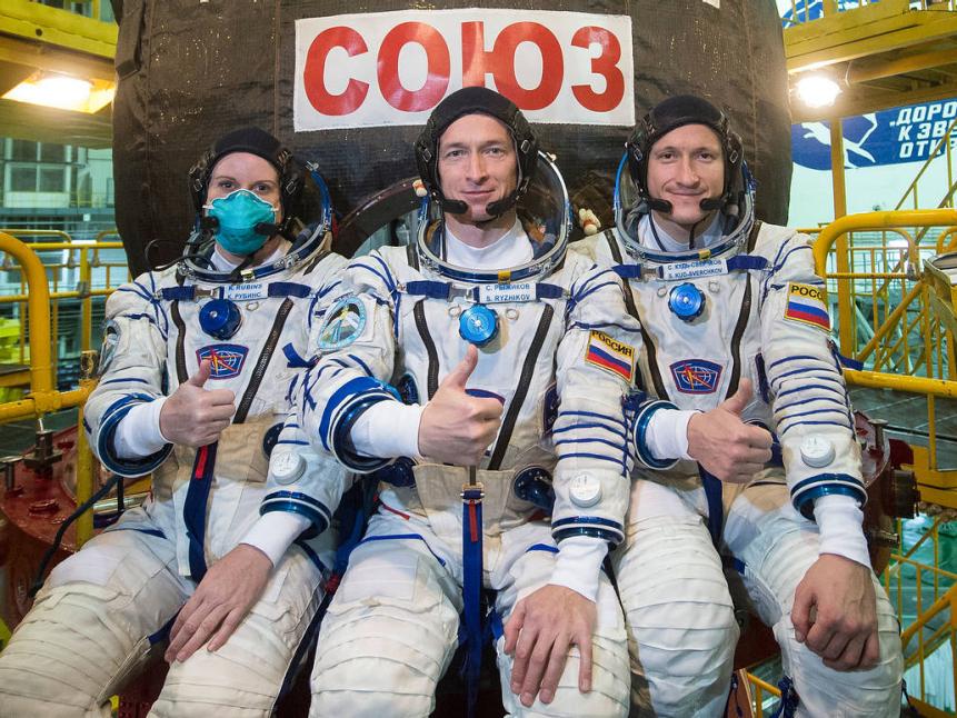 Expedition 64 NASA astronaut Kate Rubins, left, and Russian cosmonauts Sergey Ryzhikov, center, and Sergey Kud-Sverchkov, right, of Roscosmos take a moment during the Soyuz MS-17 spacecraft fit check to pose for a photograph, Monday, Sept. 28, 2020, at the Baikonur Cosmodrome in Kazakhstan. The trio are preparing for launch to the International Space Station in their Soyuz MS-17 spacecraft from the Baikonur Cosmodrome in Kazakhstan on October 14, Baikonur time. Photo Credit: (NASA/GCTC/Andrey Shelepin)