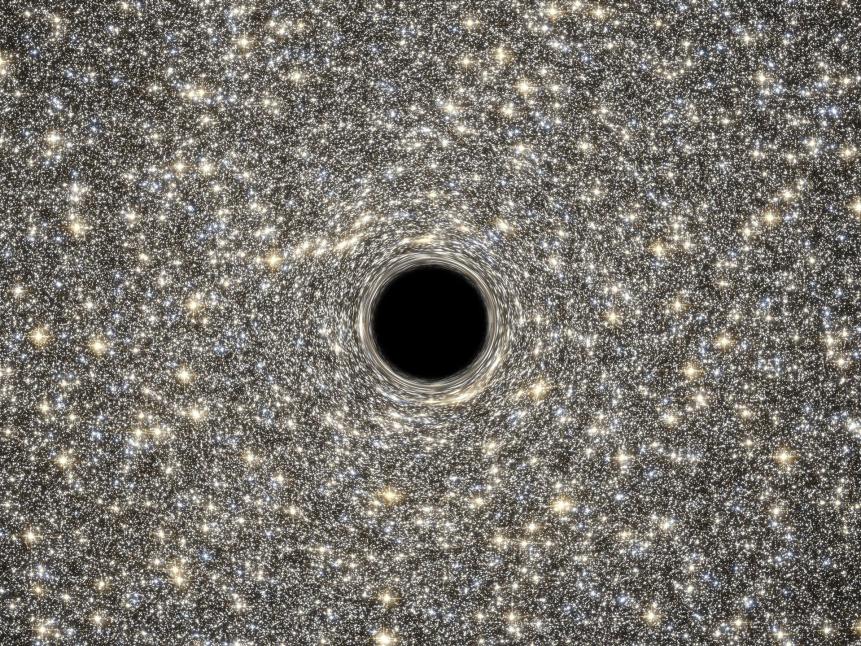 This is an illustration of a supermassive black hole, weighing as much as 21 million suns, located in the middle of the ultradense galaxy M60-UCD1. The dwarf galaxy is so dense that millions of stars fill the sky as seen by an imaginary visitor. Because no light can escape from the black hole, it appears simply in silhouette against the starry background. 