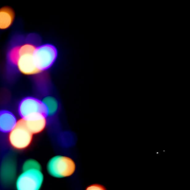 LAS VEGAS, NEVADA - DECEMBER 21:  Jupiter (L) and Saturn appear about one-tenth of a degree apart during an astronomical event known as a Great Conjunction behind Christmas lights in the front yard of a house on December 21, 2020 in Las Vegas, Nevada. The planets, which remain about 450 million miles apart in space, have not appeared this close together from Earth's vantage point since 1623, and it's been nearly 800 years since the alignment occurred at night. The conjunction, which occurs on the night of the winter solstice by coincidence, has become known popularly as the "Christmas Star." The gas giants will not appear this close together again until 2080.  (Photo by Ethan Miller/Getty Images)