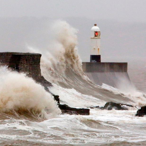 Huge waves crash against the sea wall at Porthcawl, south Wales as Storm Dennis hits the country on February 15, 2020. - As Storm Dennis sweeps in, the country is bracing itself for widespread weather disruption for the second weekend in a row. Experts have warned that conditions amount to a "perfect storm", with hundreds of homes at risk of flooding. (Photo by GEOFF CADDICK / AFP) (Photo by GEOFF CADDICK/AFP via Getty Images)