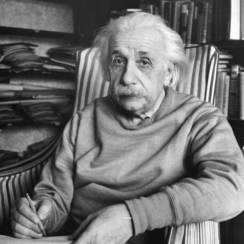 Scientist Albert Einstein wearing old sweat shirt, sitting with page of equations in home library .  (Photo by Alfred Eisenstaedt/Pix Inc./The LIFE Picture Collection via Getty Images)