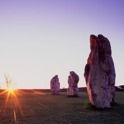 Standing Stones at Avebury at sunrise on the Vernal (Spring) Equinox, designated a UNESCO World Heritage Site, the purpose of the ancient obelisks remains an enigma