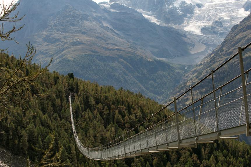 The Charles Kuonen Suspension Bridge, in the Swiss Alps, near the village of Randa, is a record-breaking 494 metres long and connects GrÃ¤chen and Zermatt on the Europaweg foot trail. It is the worldâ  s longest pedestrian suspension bridge in Switzerland.