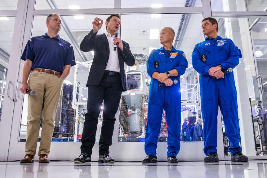 SpaceX founder Elon Musk (2nd L) addresses the media alongside NASA Administrator Jim Bridenstine (L), and astronauts Doug Hurley (2nd R) and Bob Behnken (R), during a press conference announcing new developments of the Crew Dragon reusable spacecraft, at SpaceX headquarters in Hawthorne, California on October 10, 2019. (Photo by Philip Pacheco / AFP) (Photo by PHILIP PACHECO/AFP via Getty Images)