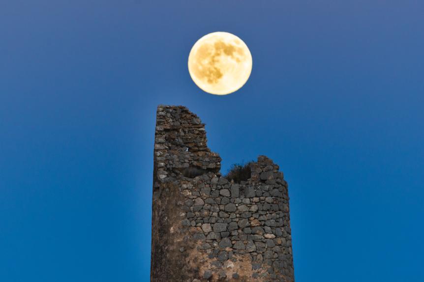 Full moon over an ancient tower. Benicassim, CastellÃ³n, Spain