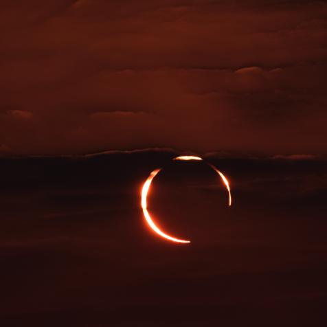 December 26, 2019. The rare Annular "ring of fire" solar eclipse as seen from the Corniche road in Doha, Qatar. Annular eclipses occur when the Moon is not close enough to the Earth to completely obscure the Sun, leaving a thin ring of the solar disc visible.